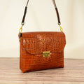 Cognac croc-print leather shoulder bag studio shot