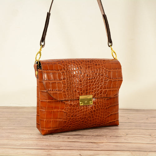 Cognac croc-print leather shoulder bag studio shot
