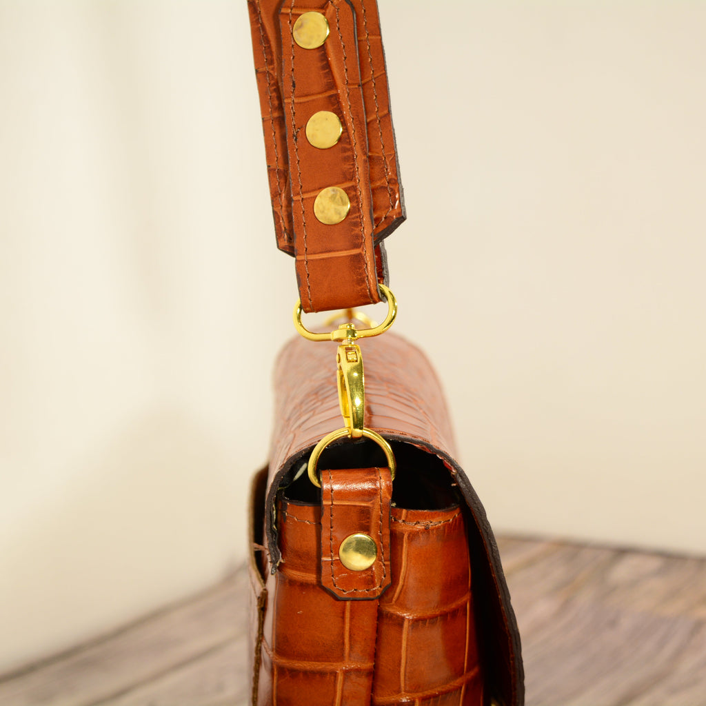 Cognac croc-print leather shoulder bag on shelf
