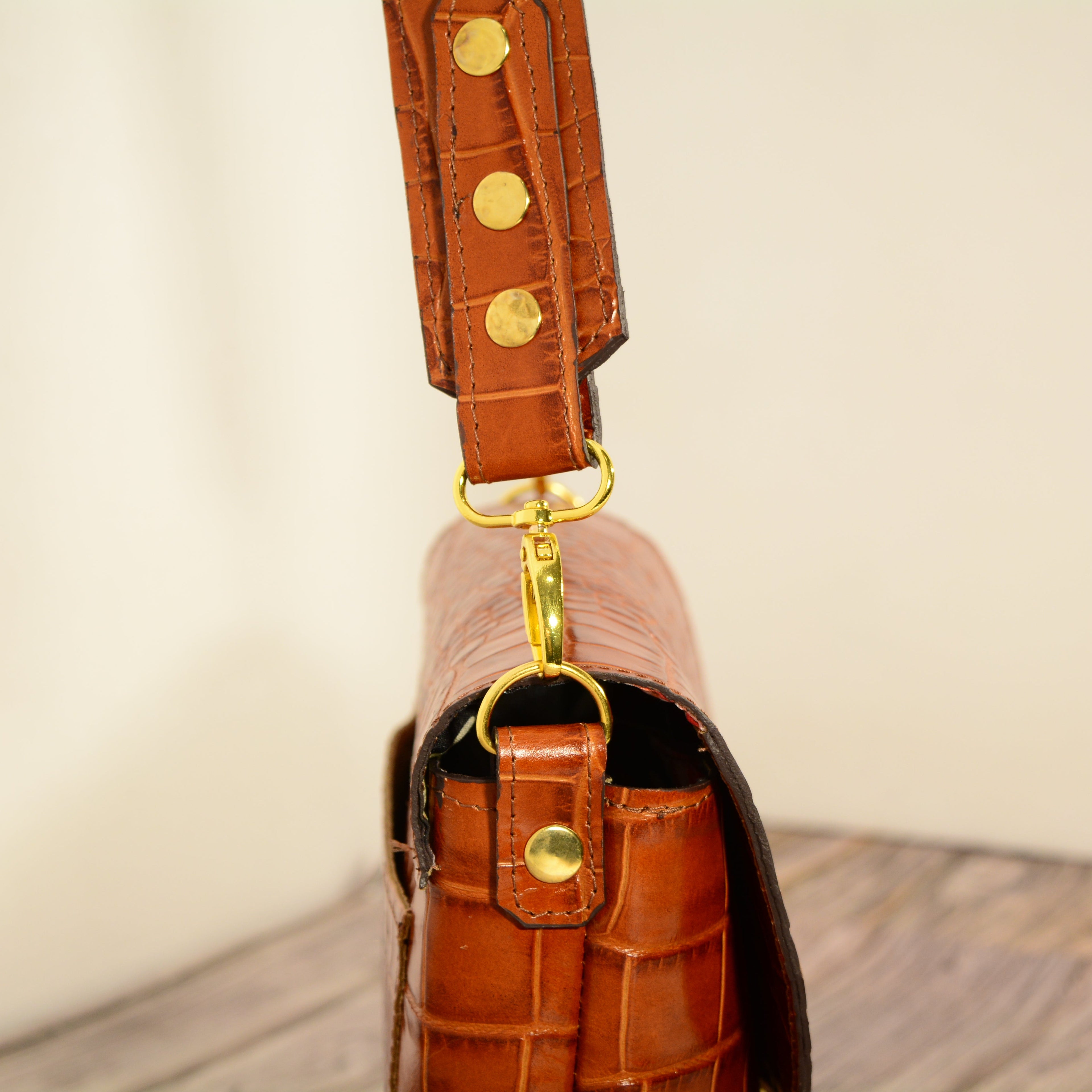 Cognac croc-print leather shoulder bag on shelf