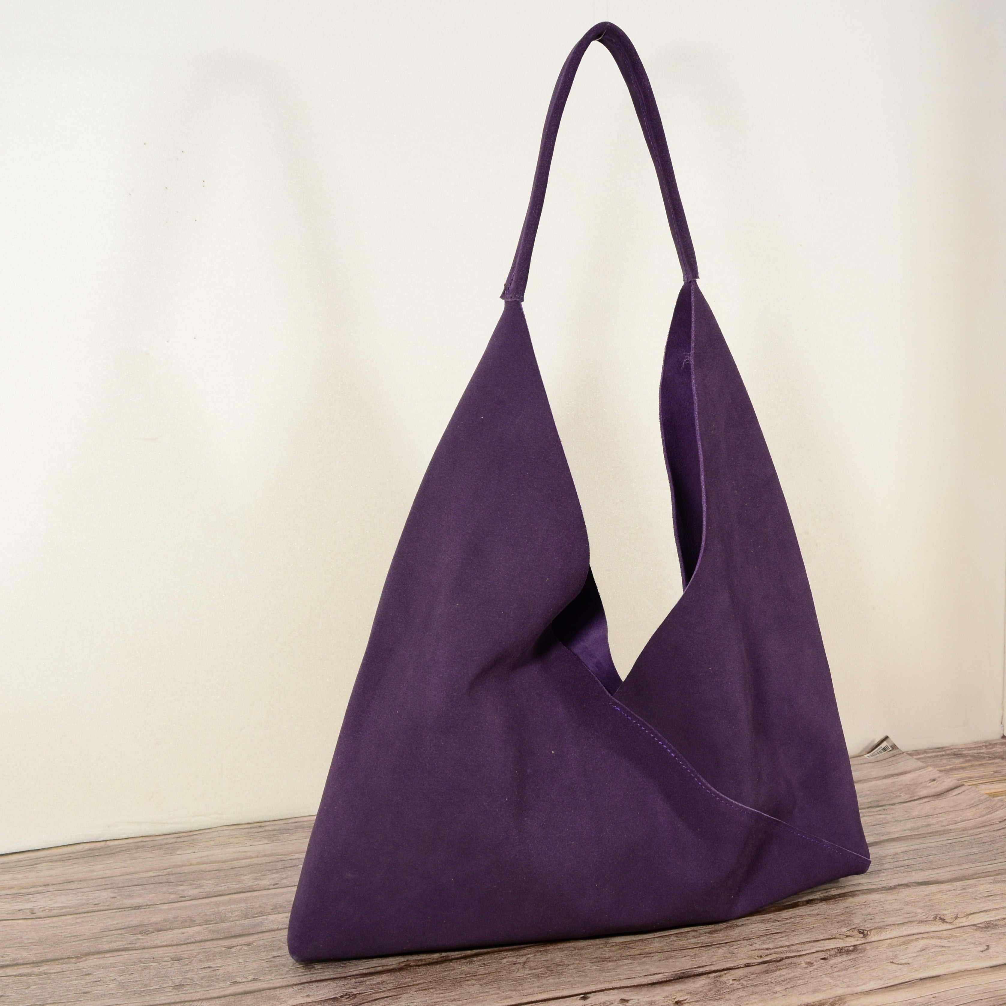 Luxury purple suede shoulder bag front view on white background