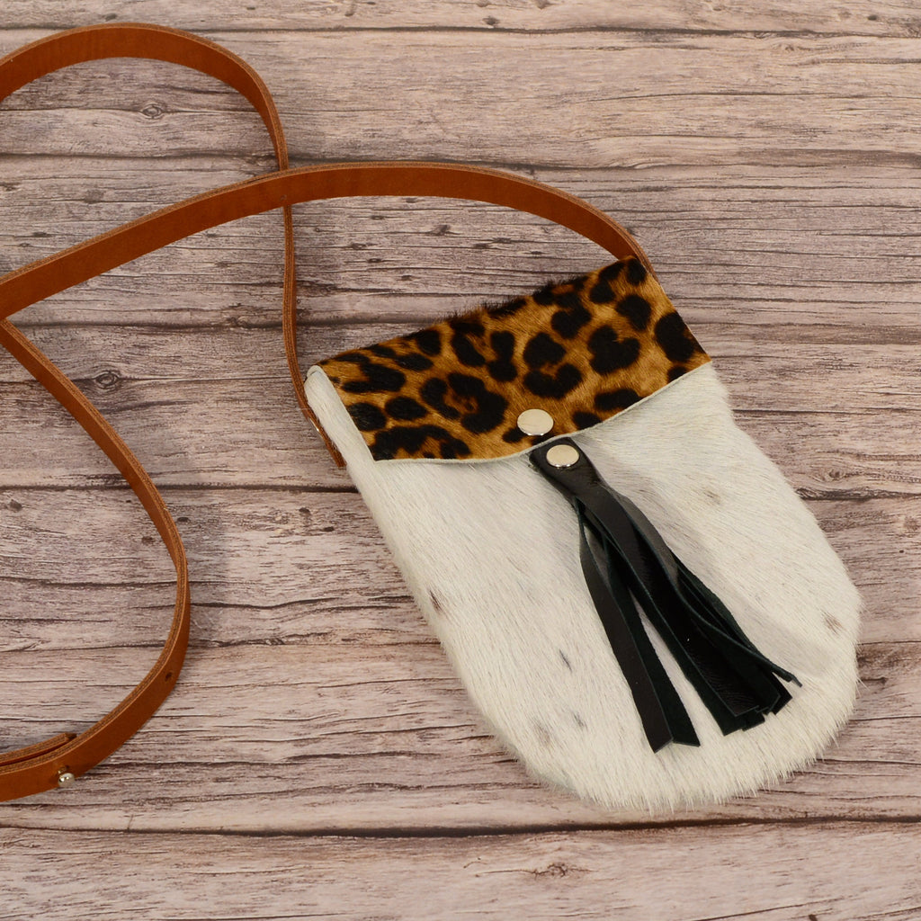 Luxury fur phone bag front view showing leopard flap and black leather tassel